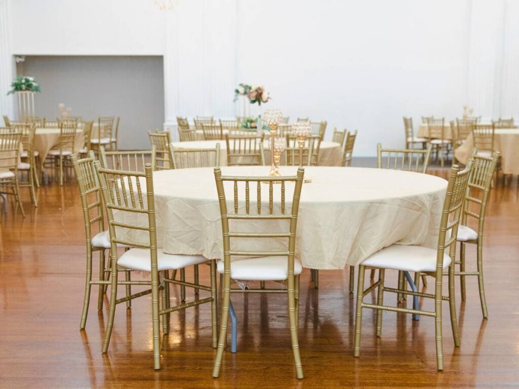 Steel chiavari chairs in gold in a event venue