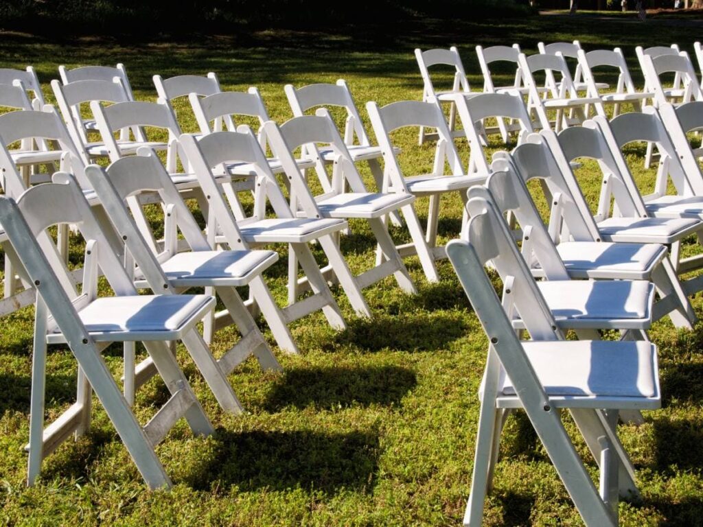 Folding chairs in a garden event

